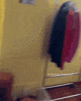 a blurred image of clothes hanging on a rack with the words christianhouse.com visible