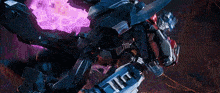 a robot is fighting another robot in a video game in a dark room .