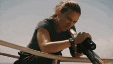a woman is holding a gun in front of a kessler logo
