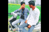 two men sitting on a scooter with youtube shorts written on the bottom right