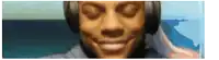 a man wearing headphones is smiling with his eyes closed