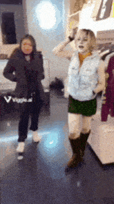 two women are standing next to each other in a store and one of them is wearing a costume
