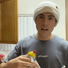 a man wearing a beanie and a gray shirt with the word georgette on it