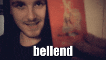 a man in a black shirt holds a box of bellend