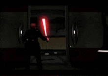 a person is holding a red light saber and a blue light is coming out of it