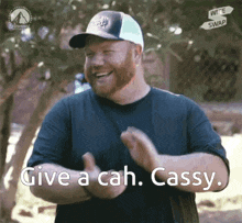 a man wearing a hat says give a cah cassy while clapping his hands