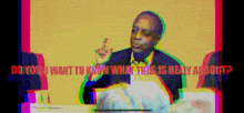 a man sitting at a table with the words " do you want to know what this is really about " behind him