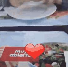 a red heart with the words muy abierto on it