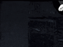 a dark room with a green arrow pointing to a white box