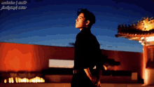a man in a black shirt is standing in front of a building with a blue sky behind him and the word tumblr on the bottom