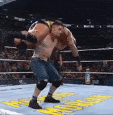 a wrestler is carrying another wrestler on his shoulders in a ring
