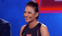 a woman with bracelets on her wrists is smiling with her hands together
