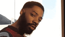a man with a beard has a tattoo on his forehead that says sondheim