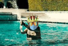 a man in a swimming pool with a crown on his head