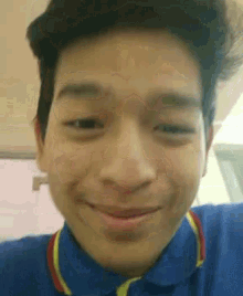 a close up of a man 's face with a smile on his face