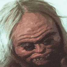 a close up of a person 's face with a very wrinkled face
