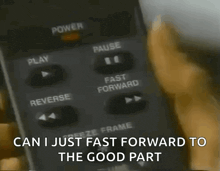 a person is pressing a button on a remote control and the words can i just fast forward to the good part are visible