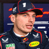 a close up of a man wearing a hat with the number 1 on it