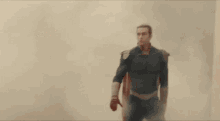 a man in a superhero costume is standing in the middle of a room .