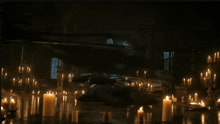 a person is laying on the floor in a room surrounded by lit candles