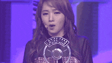 a woman stands in front of a microphone that says " ladies code "