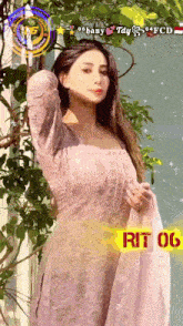 a woman in a pink dress is standing in front of a window