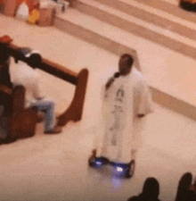 a priest is riding a hover board in a church while giving a sermon .