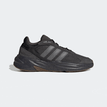 a pair of black adidas shoes with brown soles
