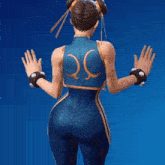a woman in a blue and gold outfit has the letter q on the back