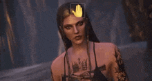 a woman with tattoos and a crown on her chest is standing in front of a yellow hand .