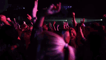a man playing a guitar in front of a crowd of people