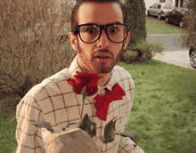 a man wearing glasses and a bow tie is holding a rose
