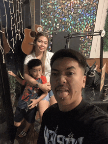 a man wearing a shirt that says ' fight ' on it poses for a photo with his family