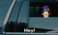 a blue car with a sticker on the window that says hey