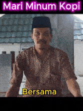 a man wearing a hat and a shirt with the words mari minum kopi written above him