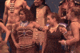 a woman in a black dress is standing next to a group of people