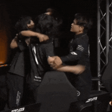 two people hugging each other in front of a chair that says lian