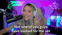 a woman sitting in front of a microphone with the words " not one of you guys have barked for me yet " above her