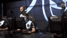 a man wearing headphones sits in front of a monitor that says zowie