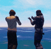 a statue of two men standing next to each other in front of a body of water