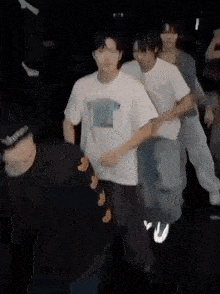 a group of people are dancing in a dark room in a blurry photo .
