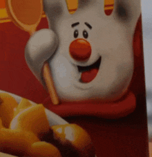 a cartoon character is holding a wooden spoon