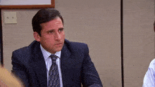 a man in a suit and tie with a pattern that says 000