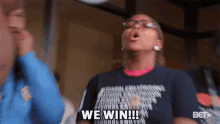 a woman in a shirt that says we win