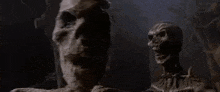 a couple of zombies standing next to each other in a dark room .