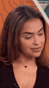 a close up of a woman wearing a black sweater