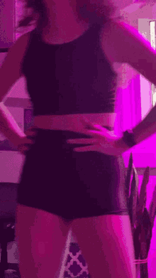 a woman is standing in front of a purple light