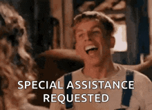 a man in overalls is laughing and talking to a woman .