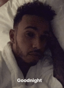 a man laying in bed with the word goodnight written on the bottom