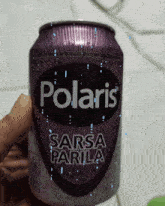 a person is holding a can of polaris sarsa parila beer